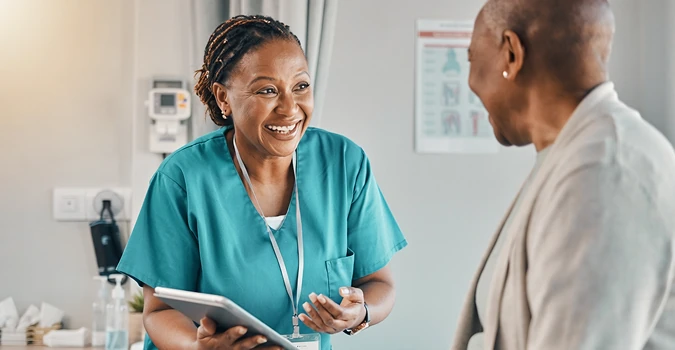 Nurse speaking with a patient in a medical office